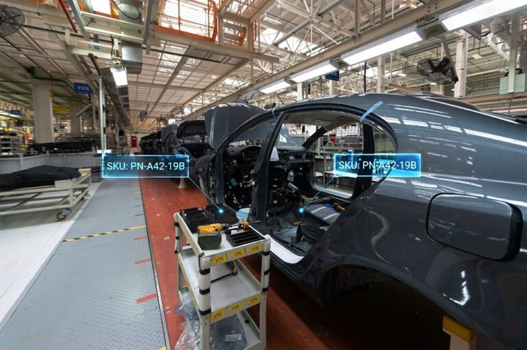 Automotive assembly line with projections showing just-in-sequence inventory management using QSSI's PowerHouse WMS software.