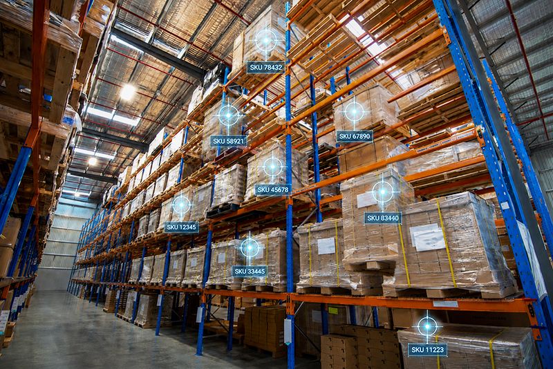 Warehouse shelves with tracking data showing the visibility into inventory that warehouses gain with PowerHouse WMS.